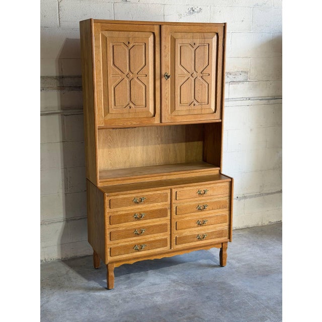 Beautiful vintage Danish hutch cabinet crafted in oak in style of Henning, featuring elegant carved geometric panel doors...