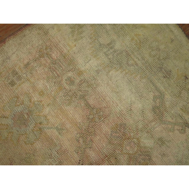 Intermediate size antique Turkish Oushak in pale colors.