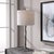 Hand cast with an organic base, this rustic lamp brings the look of nature indoors. Finished in a dark gunmetal and...