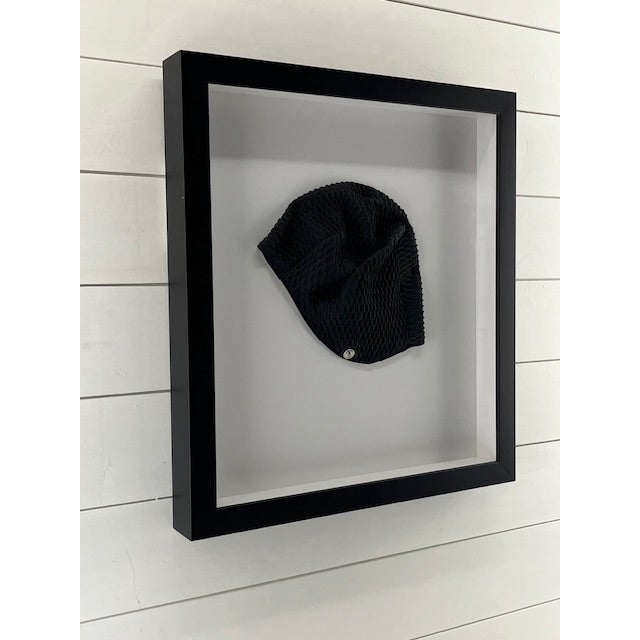 Very contemporary nautical look. Black swim cap framed in a black all wood shadow box frame with acrylic. Fun...Great for...