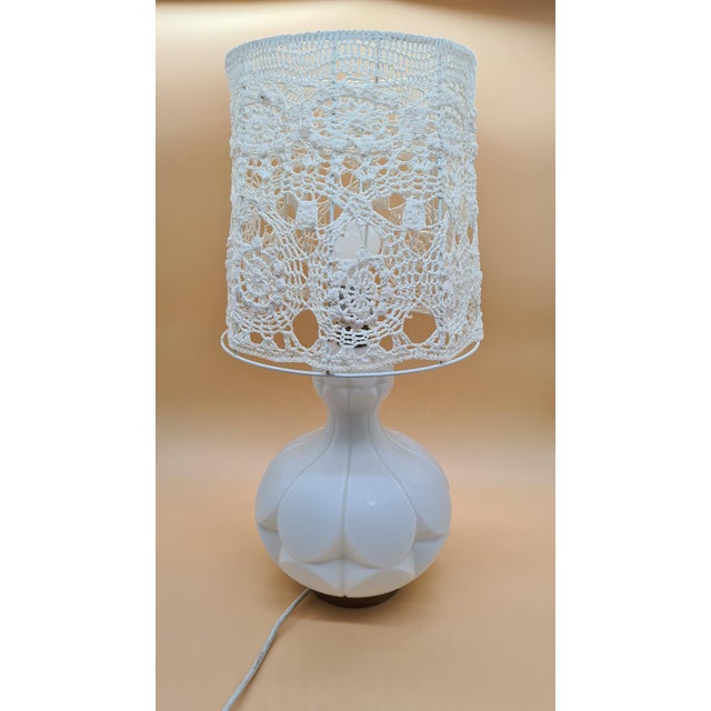 This table lamp by Peill & Putzler from the 1960s is made of frosted glass in a warm ivory shade. The rounded body, formed...