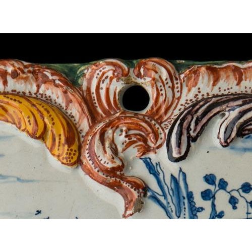 Polychrome Plaque with a courteous scene. Delft, circa 1760 The octagonal plaque is painted in blue with a courteous...