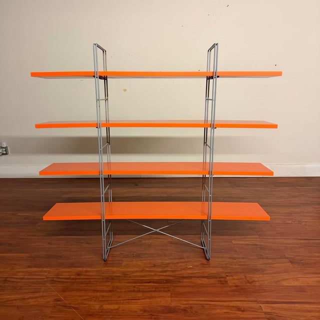 Vintage IKEA Enetri shelf, designed by Niels Gammelgaard, featuring bright orange shelves with a light grey frame. It's a...