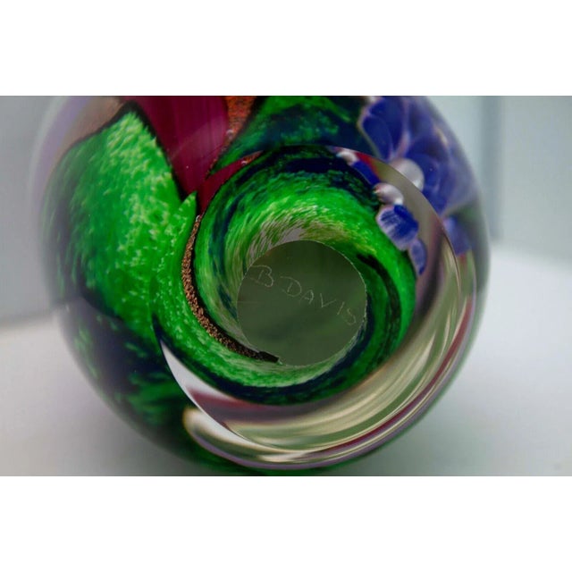 A captivating contemporary pink, purple, and green swirl design glass art sculpture by Berry Davis. Etched signature on...