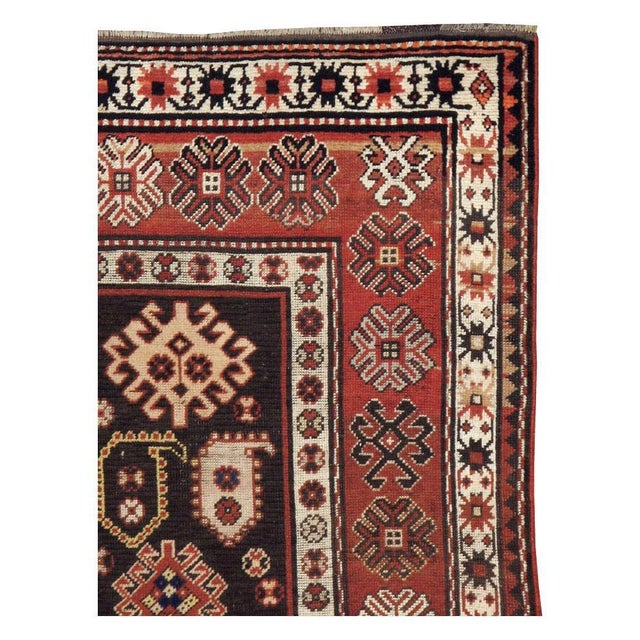 An antique Caucasian Kazak throw rug handmade during the early 20th century. Measures: 3' 6" x 5' 4".