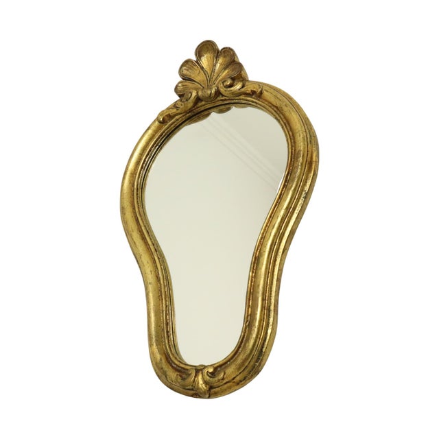 Beautiful crested mirror gilded with gold leaf; the frame is made of resin, entirely in the classic Baroque style, circa...