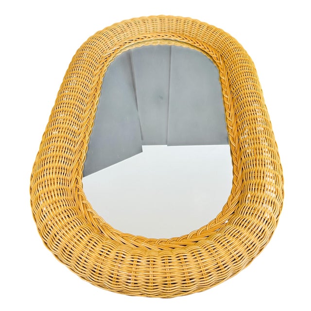 This vintage 1980s oval wall mirror brings a touch of coastal bohemian charm to any room. The natural woven wicker frame...