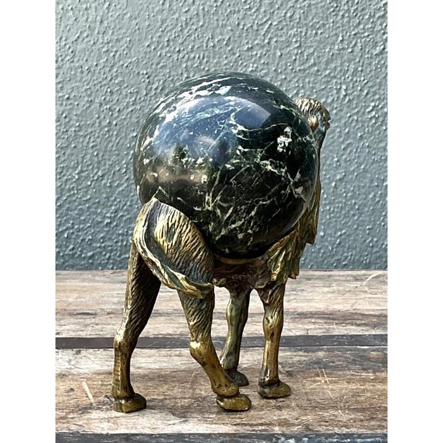 Exuding artisanal character and whimsical luxury, this vintage mid-century sculpture depicts a stylized standing camel...