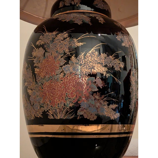 This piece features a glossy midnight-black porcelain body beautifully accented by a hand-decorated botanical pattern. Its...