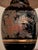 This piece features a glossy midnight-black porcelain body beautifully accented by a hand-decorated botanical pattern. Its...