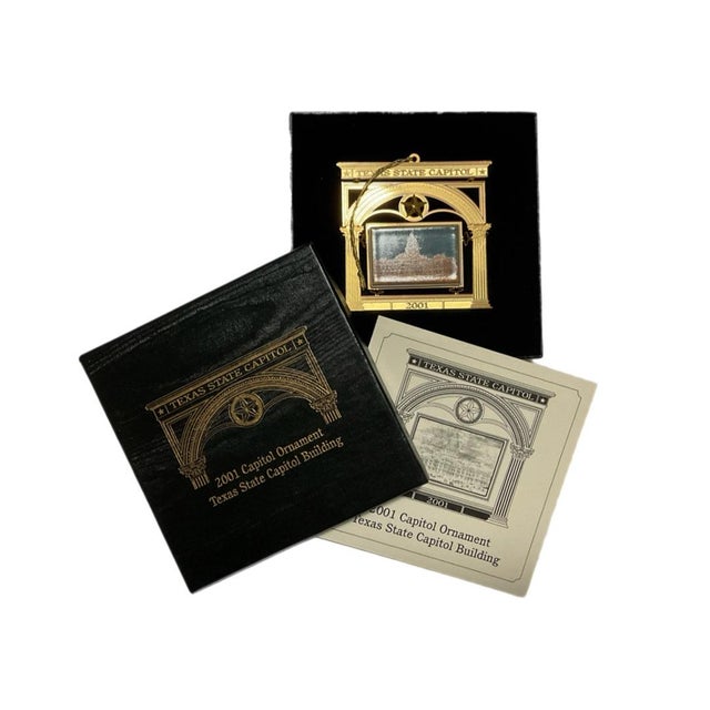 Twenty Christmas ornaments. Each ornament is in a presentation box and has a brochure providing information about the...