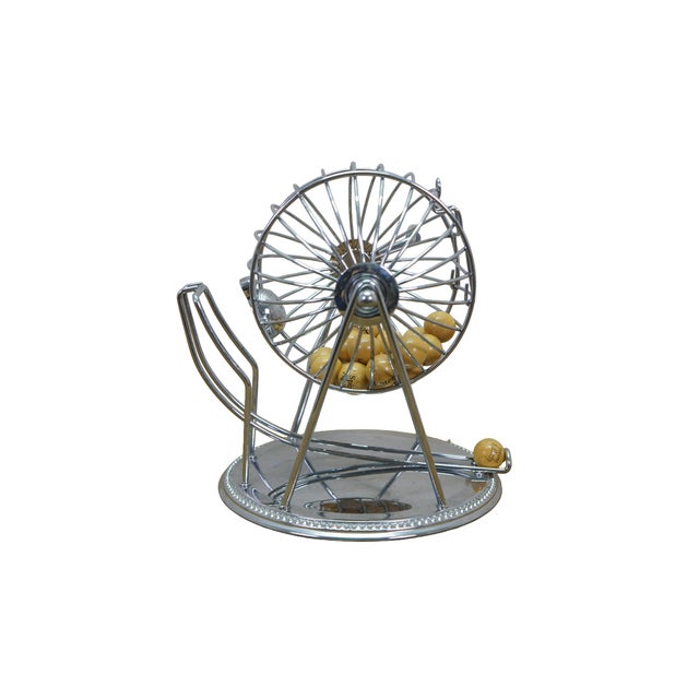 Vintage Godinger metal bingo cage featuring a revolving tumbler with novelty wooden balls that feature whimsical fortunes...