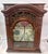 Imported from France. Ornate arched top curio cabinet with glass front, sides, and shelves. Intricately carved garland...