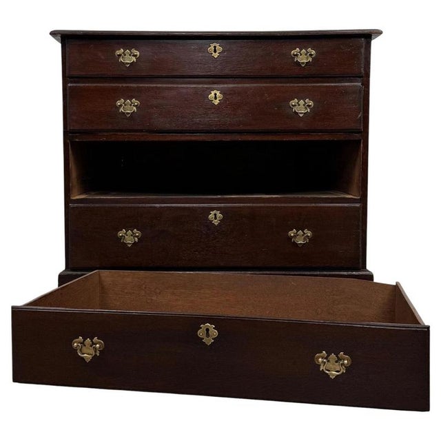 A handsome 18th-century English chest of drawers, finely constructed from oak and distinguished by its beautifully aged...