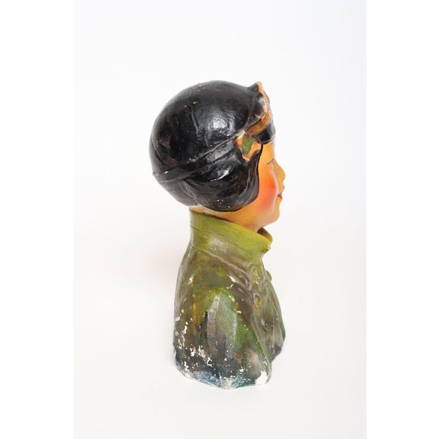 Circa 1930s polychrome chalkware bust depicting an Asian woman in traditional attire, created in the style popularized by...