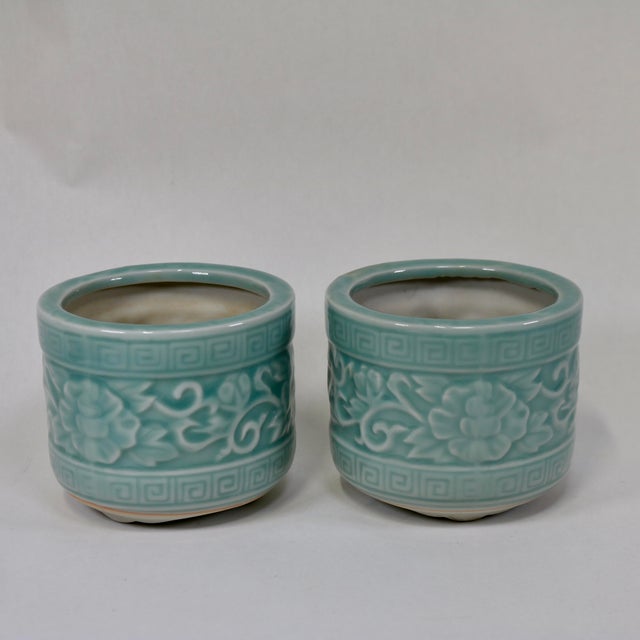 Beautiful celadon glazed porcelain planter or brush pot. These feature a relief-molded floral design with a geometric...