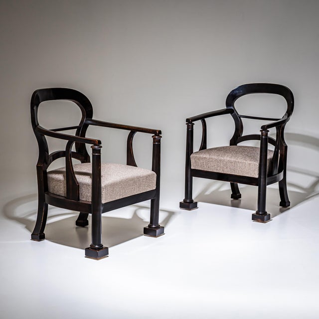 Pair of dark brown stained armchairs with balloon-shaped openwork backrests and upholstered seats. The seats have been...