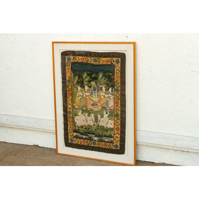 The Sacred Pasture is a vibrant window into the pastoral poetry of Indian devotional art. This vintage Pichwai is hand-...