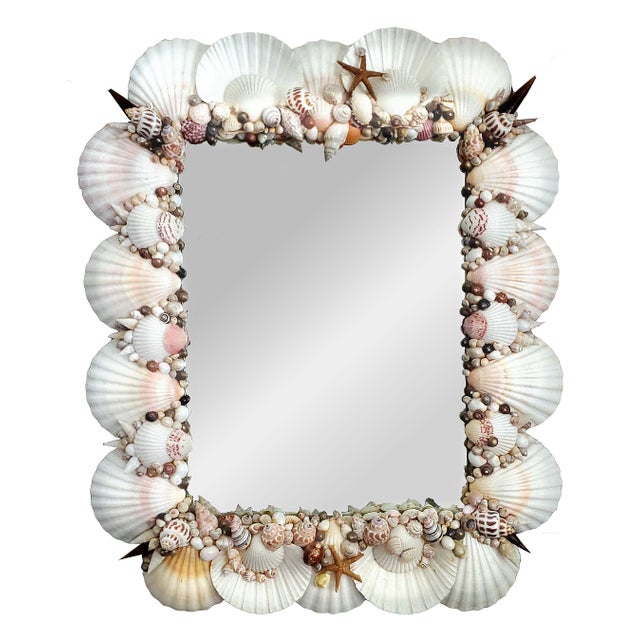 Offering a gorgeous vintage white seashell wall mirror, circa Late 20th Century. This stunning mirror is surrounded with...