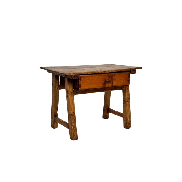 Antique oak side table, a piece that stands out for its solid presence and deep connection to artisanal tradition. Its...