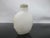 Chinese white peking glass snuff bottle with green stopper, spoon intact. Ovoid shape showing carved mask design along...
