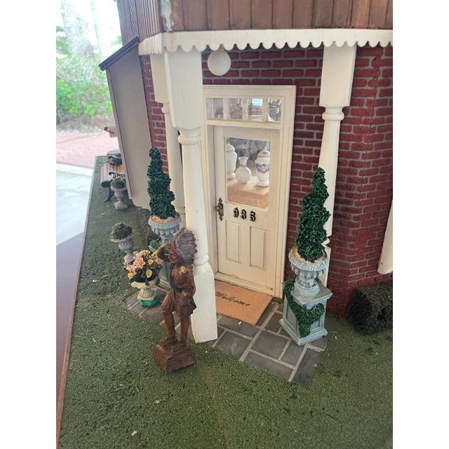 A spectacular, one-of-a-kind handcrafted dollhouse titled "The Antique Store." This architectural masterpiece serves as a...
