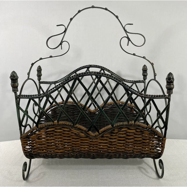 A vintage decorative magazine rack made of reed and finely carved metal in scroll and wavy design. Dimensions: 16.25" W x...