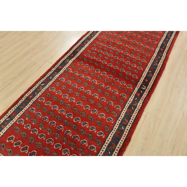 An authentic vintage tribal Mahal runner hand-knotted with fine wool and natural dyes. This oriental rug features an all-...