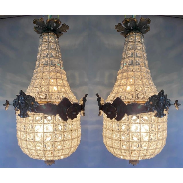 This elegant pair of circa 1960s French Louis XVI–style chandeliers combines solid bronze construction with an unusual...
