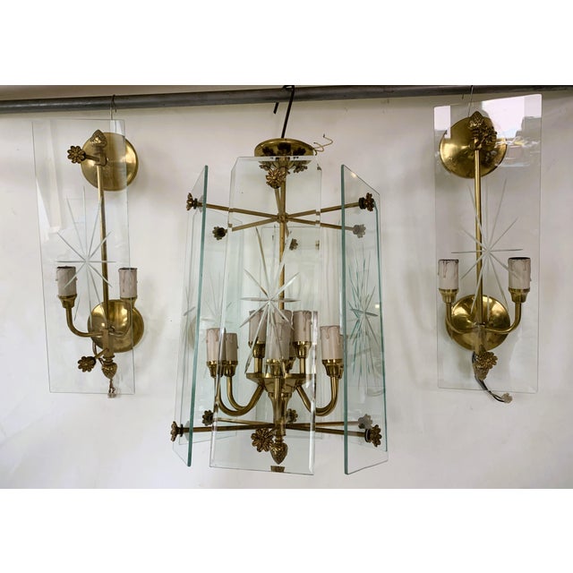 I offer a unique set of 2 large 50cm wall lamps and a chandelier for 12 light points from the 70s, from a polish...