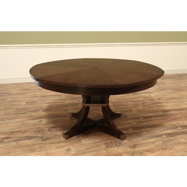 Large 64"-84" Cherry Jupe table with acid-washed brass accented feet. Casual medium brown finish. This table has self-...