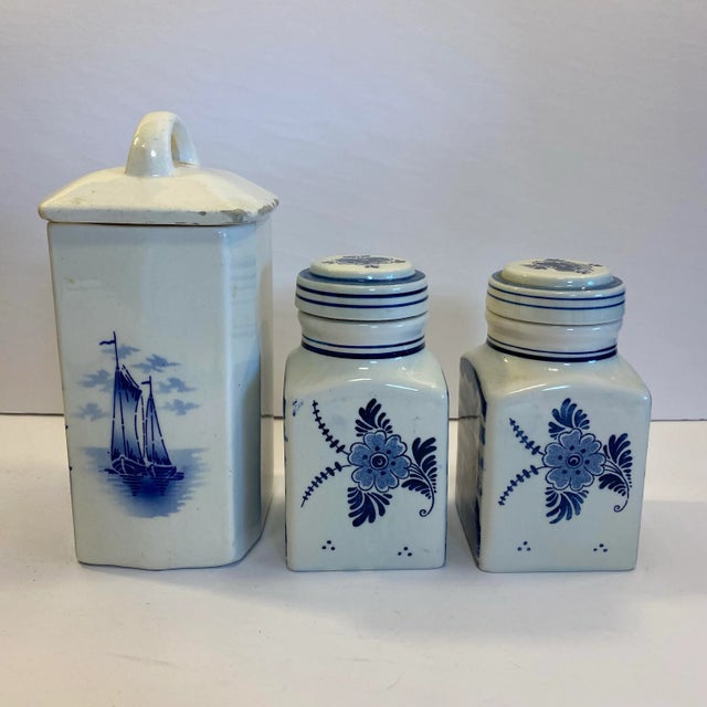 A collected trio of vintage European blue-and-white ceramics, bringing together a German coffee canister and two...