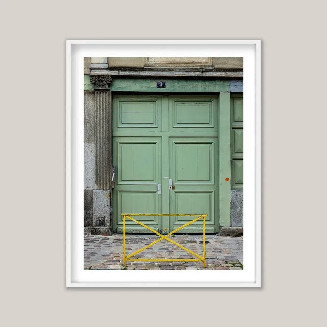 Historic European architecture often reveals its character at street level through tall, double doors - sometimes ornate,...