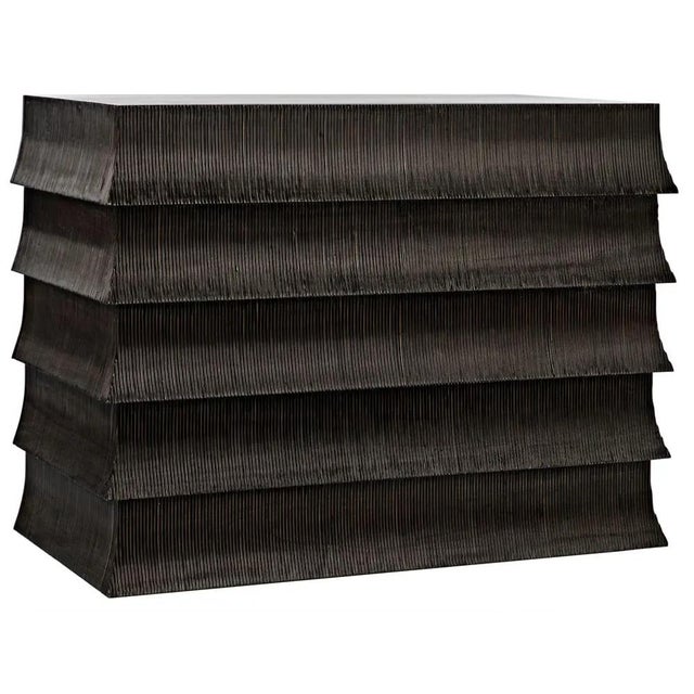 Ruffled carvings inspired by the dresses worn by flappers in the 1930s elevate the 5-drawer Eva dresser far above the...