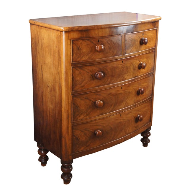 An exceptional antique 19th Century Victorian Tallboy Dresser. Features a mahogany frame with bowfront and two over three...
