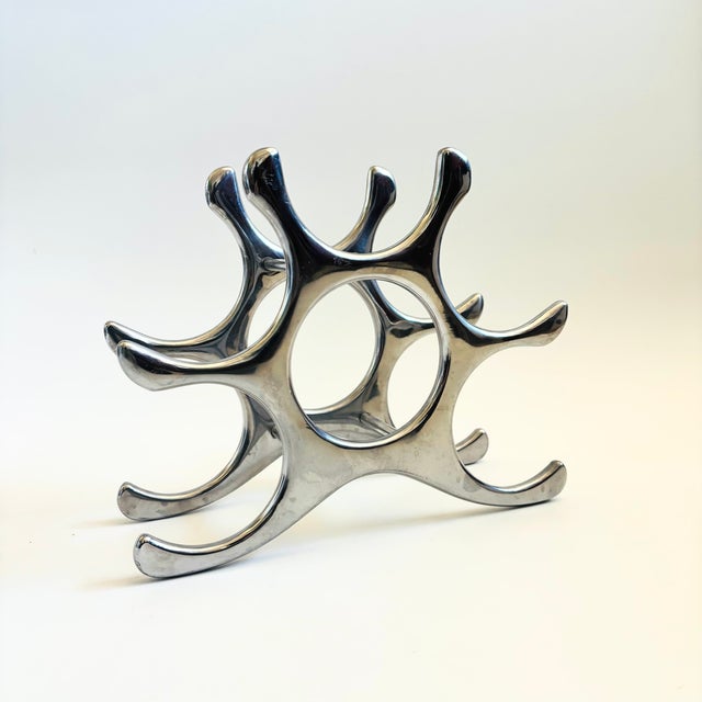 A vintage aluminum table top wine rack designed by Michael Noll. Great sculptural shape that can hold up to 6 bottles....