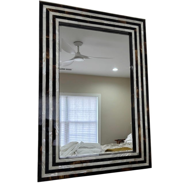 Bring elegance and sophistication to any interior with this stunning mother-of-pearl inlaid mirror. The handcrafted frame...