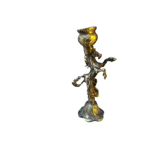 Pair of handmade brass candle holders with rearing horse figures. Sold as a set of two, these candlesticks feature...