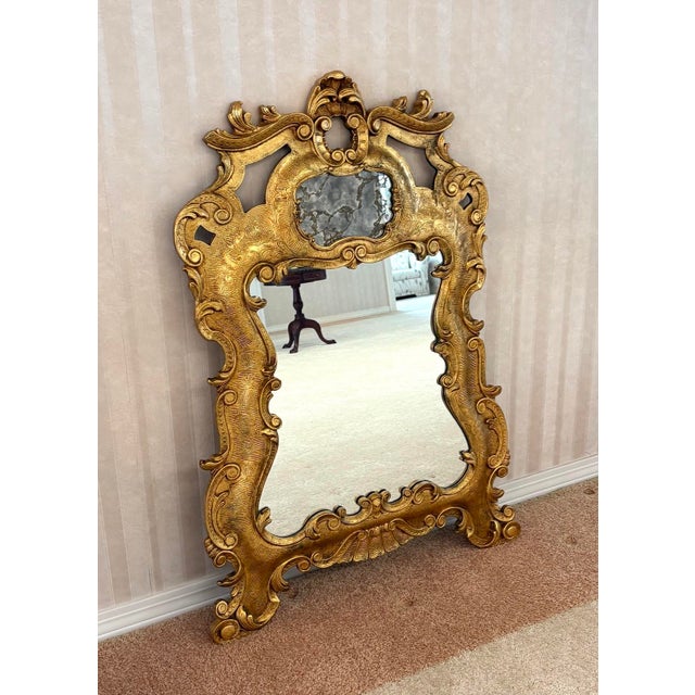 1960s-70s large ornate giltwood-frame wall mirror. Excellent condition. Measures 49" x 31.5" including frame.