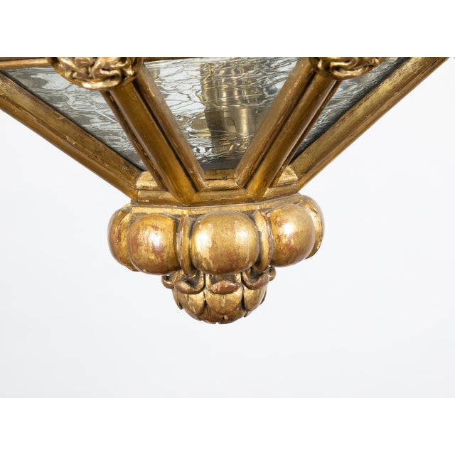 A French Baroque style giltwood lantern from the early 20th century, with volutes and textured glass. Created in France at...