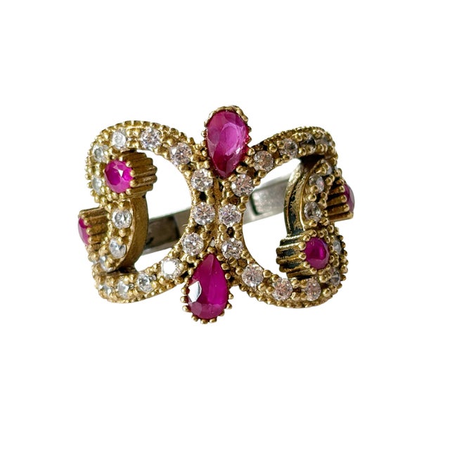 This fabulous vintage sterling silver statement ring features ruby and sparkling round diamonds set in an open work...