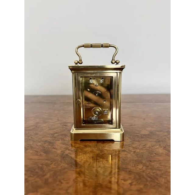 Quality antique Victorian French brass carriage clock having a quality brass case with bevelled glass, white enamel dial...