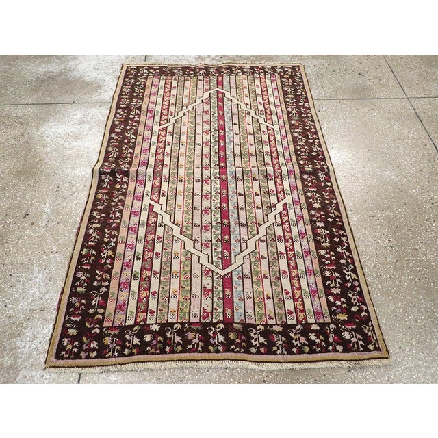 This Early 20th century Turkish Ghiordes rug, measuring 3' 6" x 5' 4", showcases the distinctive village weaving...