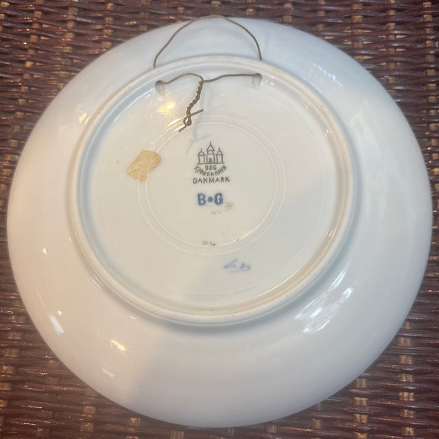 Porcelain Christmas plate from Bing & Grondahl (B&G) of Denmark, featuring a stable scene with two horses and the...