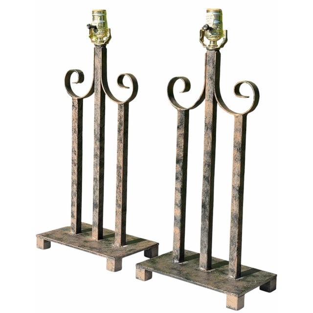 Striking pair of vintage Neoclassical table lamps crafted in substantial metal with a strong architectural form. Each lamp...