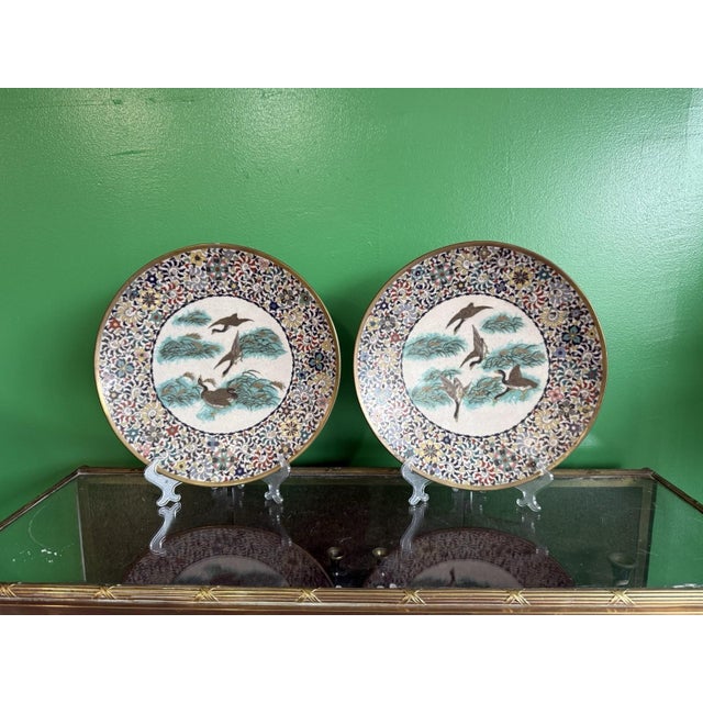 This exceptional pair of Japanese cloisonné enamel dishes, each measuring approximately 12 inches in diameter, dates to...
