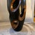 A vintage wooden vase with a highly artistic and sculptural design The vase is made of wood, showcasing a dark polished...