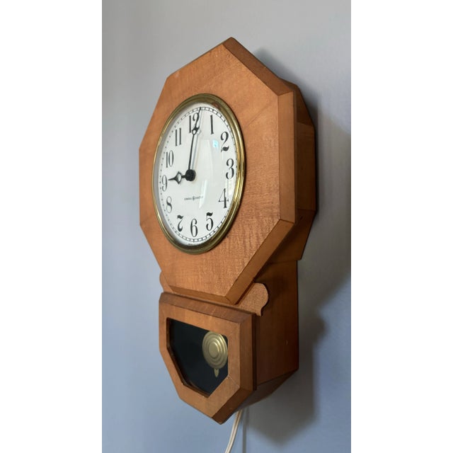Vintage midcentury modern General Electric Telechron Pendulum Wooden Wall clock with brass accents and pendulum. Measures...