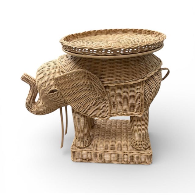 Add a touch of whimsical sophistication to your interior with this vintage sculptural wicker elephant side table....