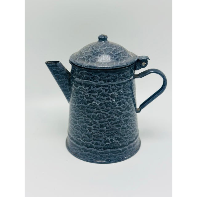 This charming vintage graniteware coffee pot features a classic tapered form with a hinged domed lid, angled spout, and...